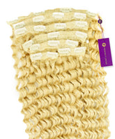 Perfect Locks Tight Curly Classic Clip-In Hair Extensions in platinum blonde with tight, defined waves and a purple tag attached.#color_platinum-blonde-(613)