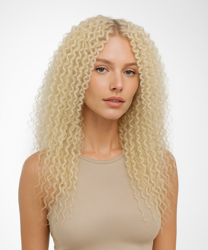 Woman with long, wavy blonde hair against a white background#color_platinum-blonde-(613)