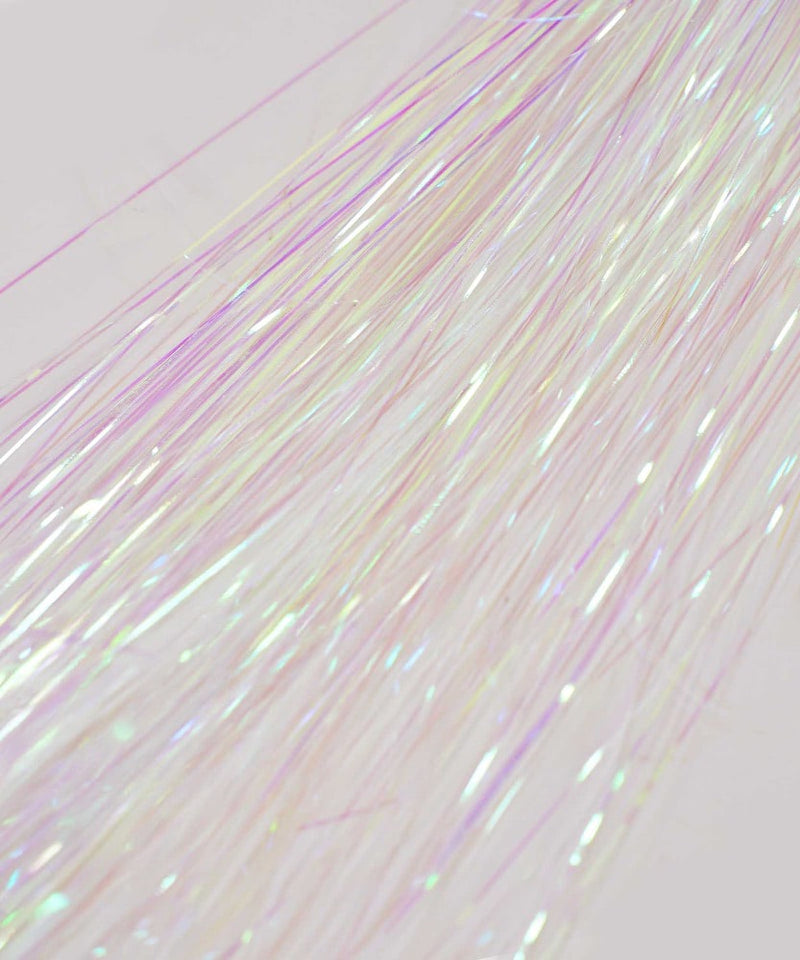 Close-up of shimmering Perfect Locks Hair Tinsel Starter Kit in unicorn, with iridescent pink, purple, and white strands reflecting light.#color_unicorn