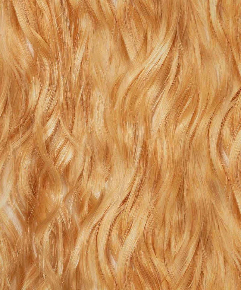 Close-up of long, wavy, platinum blonde hair with a shiny, smooth texture, featuring I-Tip extensions in color 613.
