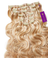 Wavy Seamless Clip-In Hair Extensions with golden blonde highlights from Perfect Locks, neatly arranged with a brand tag on the right.#color_golden-blonde-highlights-(16/22)