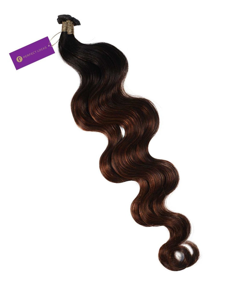 Perfect Locks Wavy Hybrid Weft Hair Extensions in Rooted Chocolate Golden Brown with long, glossy waves and a purple branded tag.