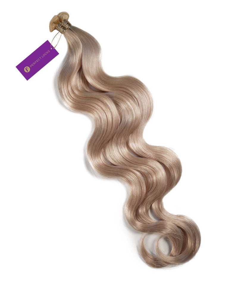 A bundle of Perfect Locks Wavy Hybrid Weft Hair Extensions in Honey Blonde  with a purple tag on a white background.