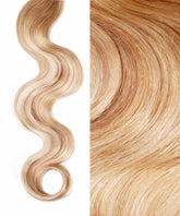 Close-up of Perfect Locks Wavy Invisi Tape In Hair Extensions in champagne highlights, with a loose wave left and detailed strands right.#color_champagne-highlights-(18A/18/60)