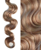A close-up and full view of wavy, jet black hair with shiny, smooth texture, defined waves from Perfect Locks extensions on white.#color_champagne-highlights-(18A/60)