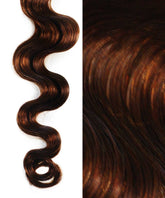 Close-up of Perfect Locks Wavy Invisi Tape In Hair Extensions in Silvery Ash Brown, defined wave left and rich textured hair right.#color_medium-brown-(4)