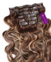 A set of Perfect Locks Wavy Seamless Clip-In Hair Extensions in Rooted Ash Blonde Highlights (4/26/4), laid flat with clips and a purple Perfect Locks tag.#color_rooted-ash-blonde-highlights-(4/26/4)