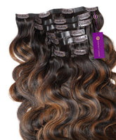 Wavy Seamless Clip-In Hair Extensions from Perfect Locks in rooted mocha bronde highlights, with black clips and a purple tag.#color_rooted-mocha-bronde-highlights-(2/6/2)