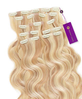 Highlighted pearl blonde Wavy Seamless Clip-In Hair Extensions by Perfect Locks, arranged in rows with white clips and a purple tag.#color_highlighted-pearl-blonde-(8/26/613)