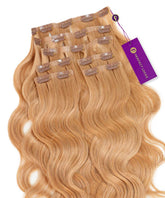 Wavy Seamless Clip-In Hair Extensions by Perfect Locks in Rooted Golden Brown (1B/5) are neatly arranged in rows, each with a purple Perfect Locks tag.#color_honey-blonde-(27)