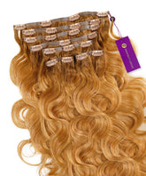 A set of Perfect Locks Wavy Seamless Clip-In Hair Extensions in rooted cool brown with labeled clips and a purple branded tag.#color_rooted-cool-brown-(1B/6)