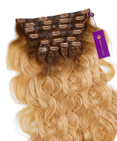 A set of Perfect Locks Wavy Seamless Clip-In Hair Extensions in Rooted Golden Brown (1B/5), laid flat with clips and a purple Perfect Locks tag.#color_rooted-golden-brown-(1B/5)