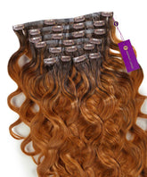 A set of Perfect Locks Wavy Seamless Clip-In Hair Extensions in Stunning Brown Balayage (3/6), laid flat with clips and a purple Perfect Locks tag.#color_stunning-brown-balayage-(3/6)