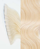 Close-up of Perfect Locks Wavy Classic Tape-In Hair Extensions in Golden Brown : wefts on the left, smooth waves on the right, white background.#color_ash-blonde-(60)
