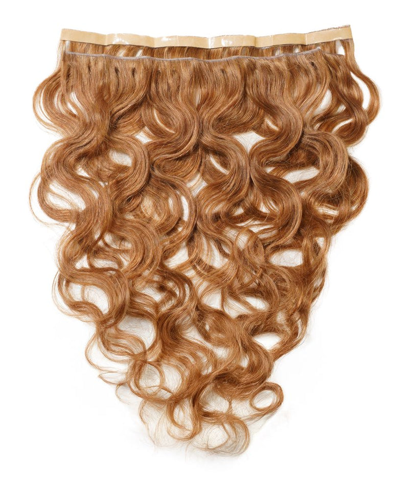 The Perfect Locks Wavy Seamless Tape In Weft in Golden Brown  features wavy Remy hair extensions on a white background.