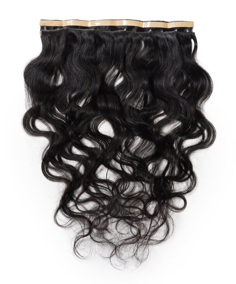 Perfect Locks' Wavy Seamless Tape In Weft in Natural Black  with loose waves and shine, displaying Remy hair quality.