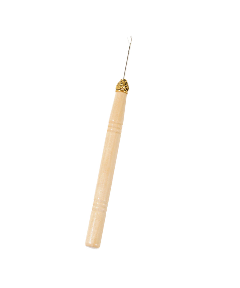 A wooden handled crochet hook with a thin metal tip, commonly used for crocheting, rests on a white background.