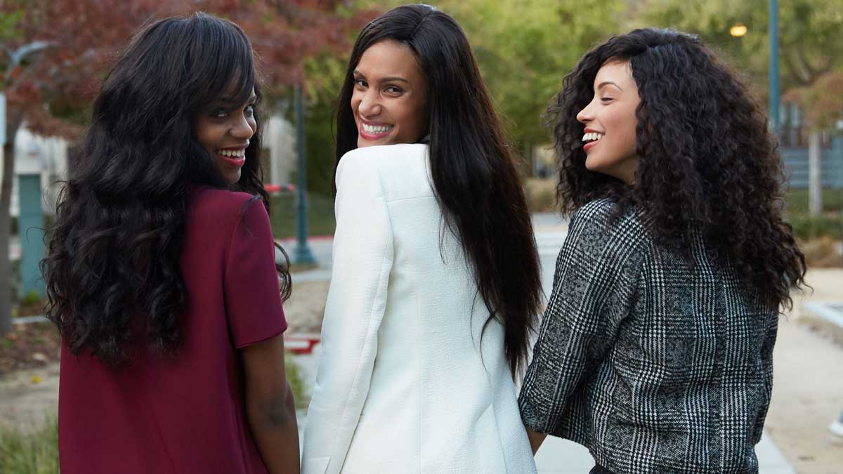 Group of women wearing straight, wavy, and curly human hair extensions