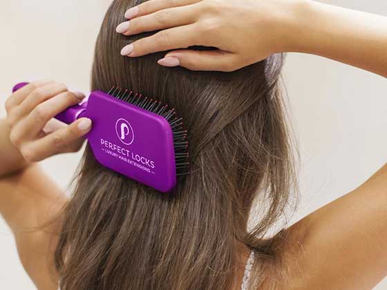 Woman Brushing Hair With Hair Extension Loop Brush