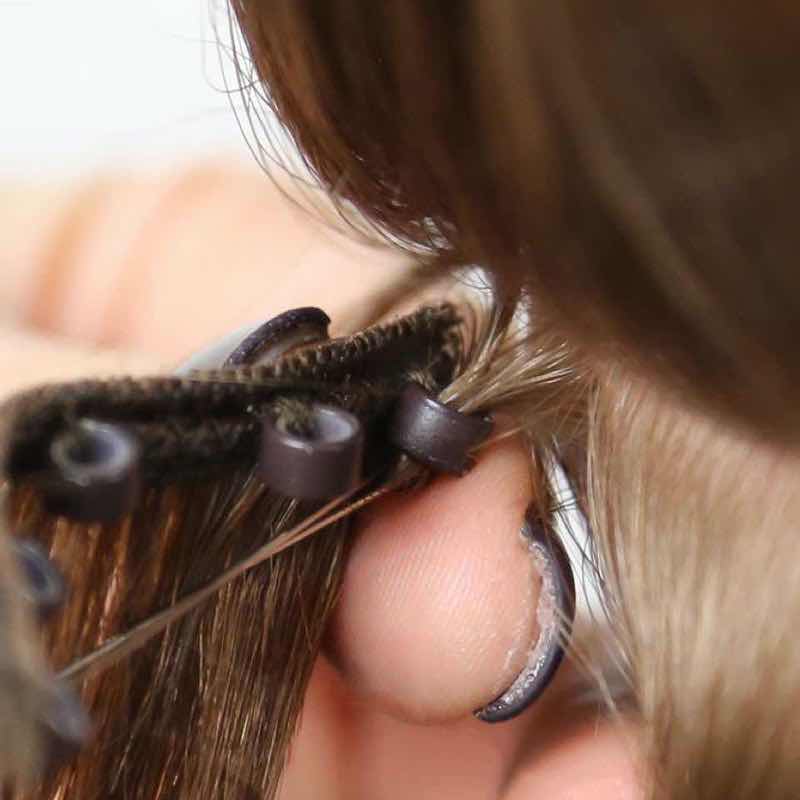 Step 3: Pull the bead through. Keep the bead close to the scalp, while still holding the strand of the na...