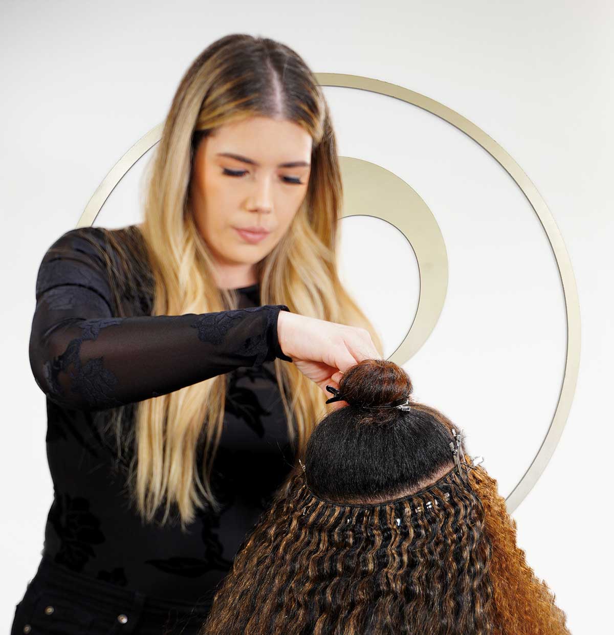 Hair Stylist Installing Weft Hair Extensions