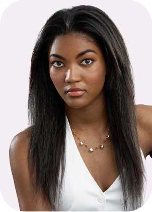 A woman with sleek, long black hair wears a white sleeveless top and a gold necklace, gazing at the camera against a light background.