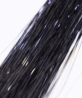 Close-up of multiple long, thin, shiny bronze strands of Perfect Hair Tinsel by Perfect Locks grouped together against a white background.#color_black