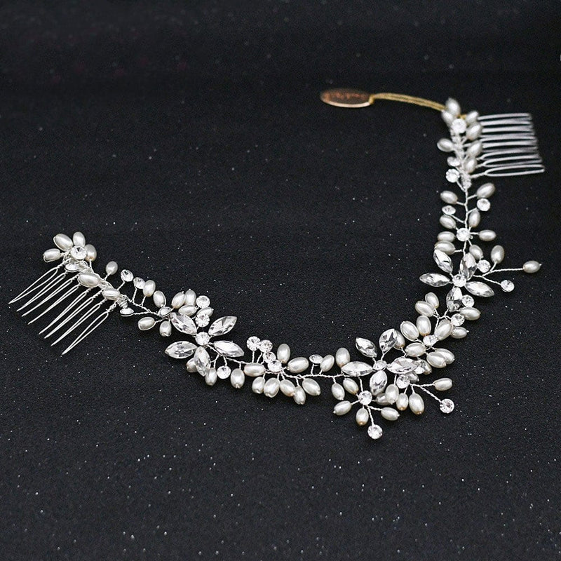 A delicate hair accessory with silver combs at each end, featuring clusters of white pearls and clear crystals in a floral and leaf pattern for an elegant touch.