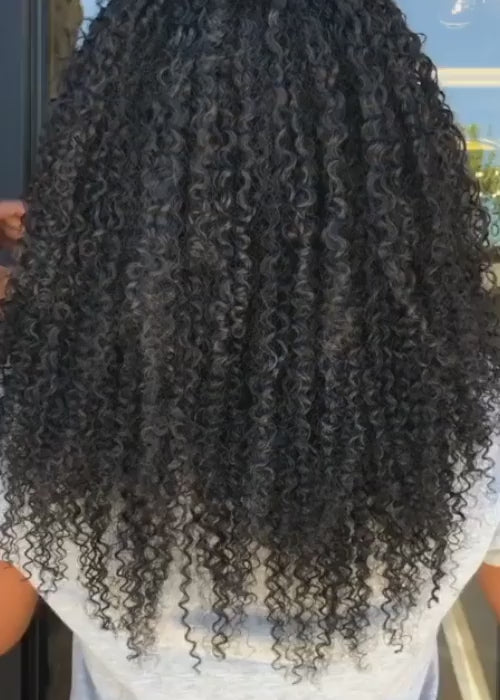 model wearing tight curly hand tied weft - video preview