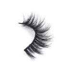 A single strip of dramatic, thick, black false eyelashes with a curved shape showcased on a white background for a bold look.