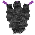 Three bundles of luxurious, wavy black human hair extensions with purple tags on a white background, shiny and voluminous.