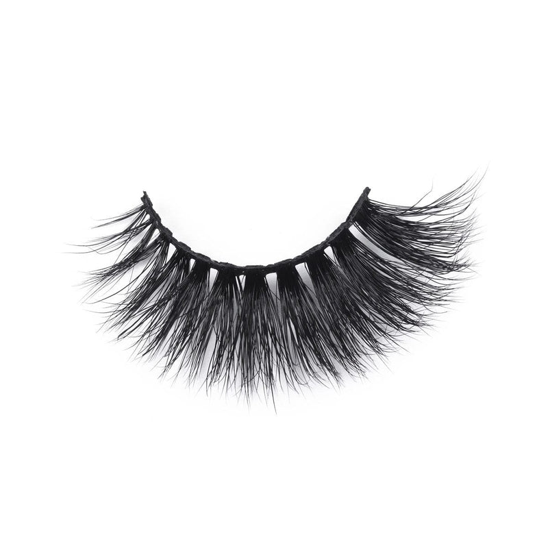 A single, curved strip of thick, black faux mink eyelashes with long, wispy fibers rests isolated on a white background.