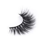 A single false eyelash with thick, long, and wispy black fibers, curved for a dramatic look, displayed on a white background.