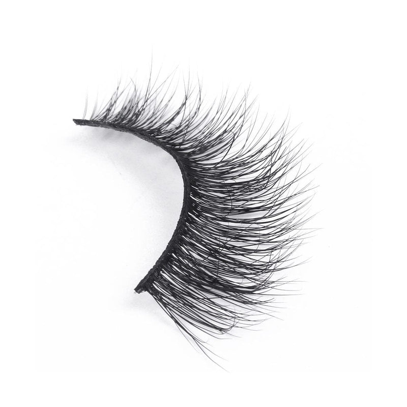 A single false eyelash with densely packed, long, wispy black fibers curves to fit the eyelid on a plain white background.